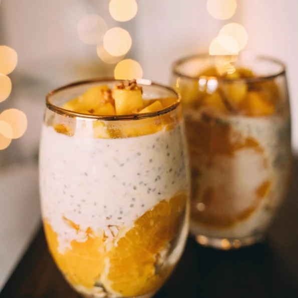 Glasses of Mango and Orange Chia Pudding on Wooden Tray