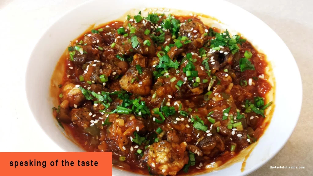 Close-up of golden-brown Mushroom Manchurian, served with a side of chili sauce