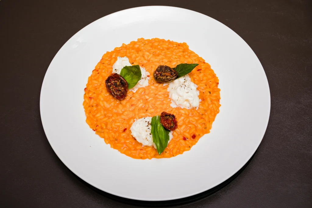 Homemade Risotto Milanese served on a rustic wooden table