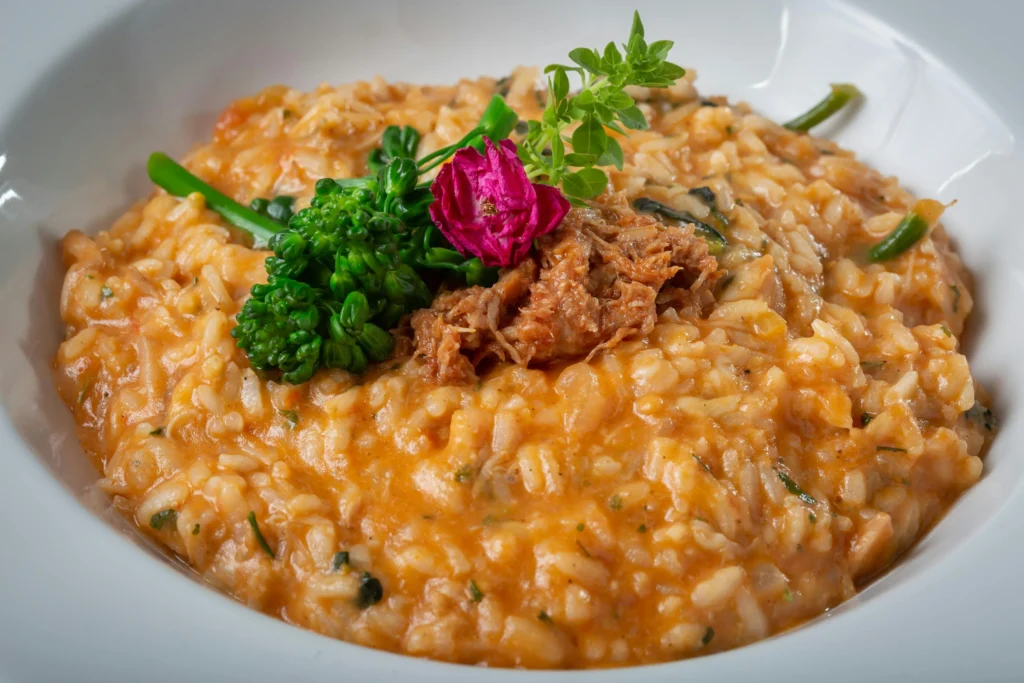 Vibrant yellow Risotto Milanese topped with fresh parsley leaves