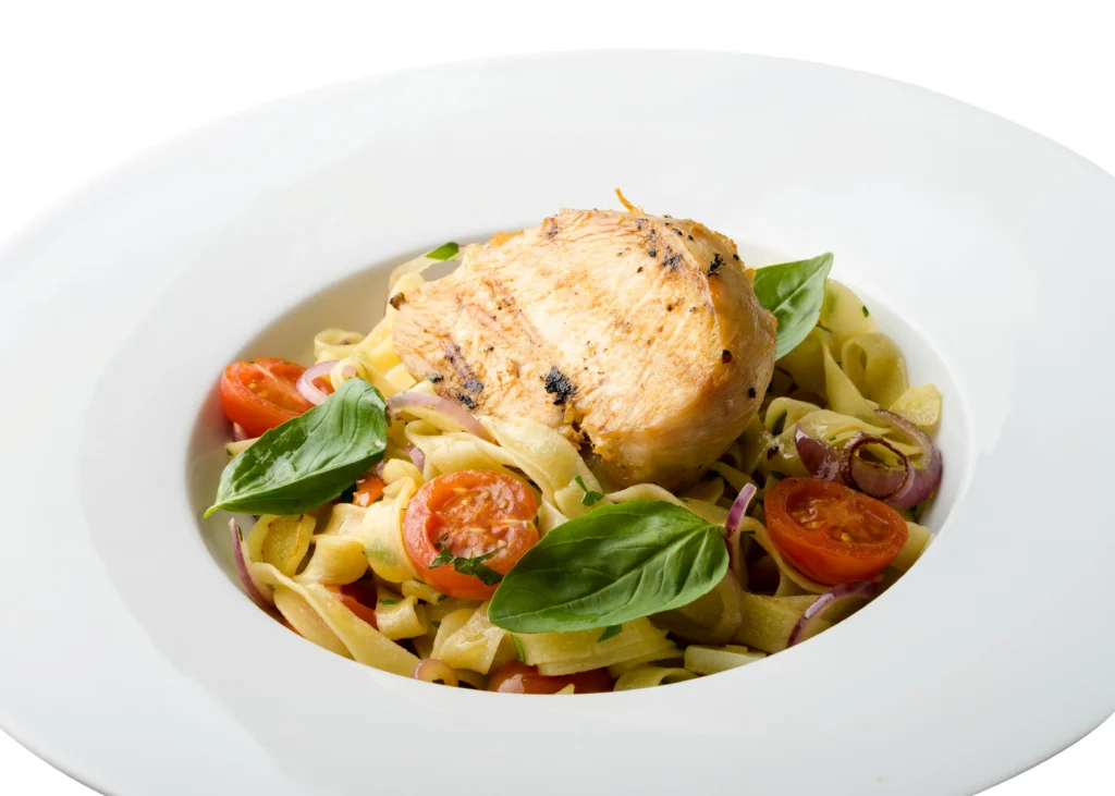 Delicious Chicken Pasta Primavera in a creamy sauce, served in a white bow