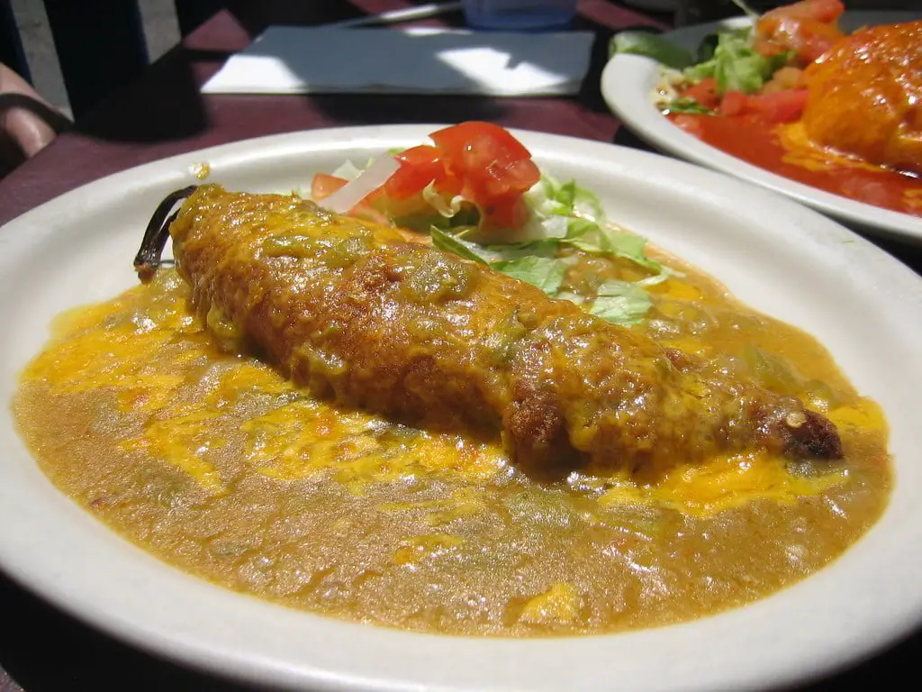 A platter of Chiles Rellenos, arranged beautifully with vibrant colors and enticing textures