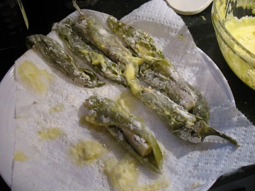 Homemade Chiles Rellenos served with salsa, sour cream, and garnished with cilantro