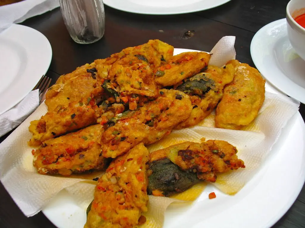 Chiles Rellenos being prepared: poblano peppers stuffed with cheese, coated in egg batter