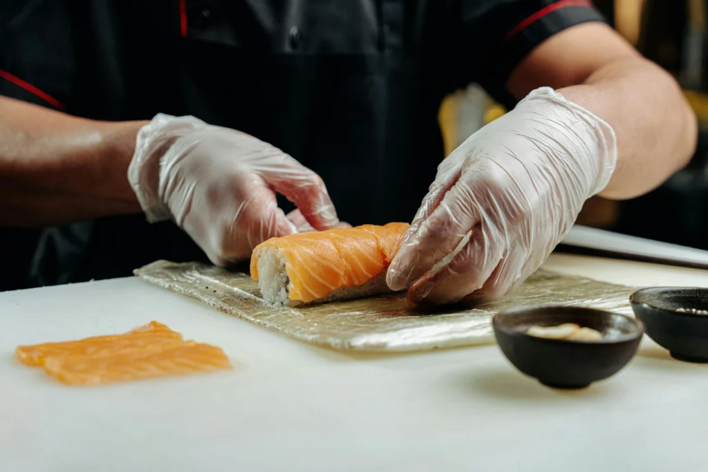 A Chef Making california roll sushi