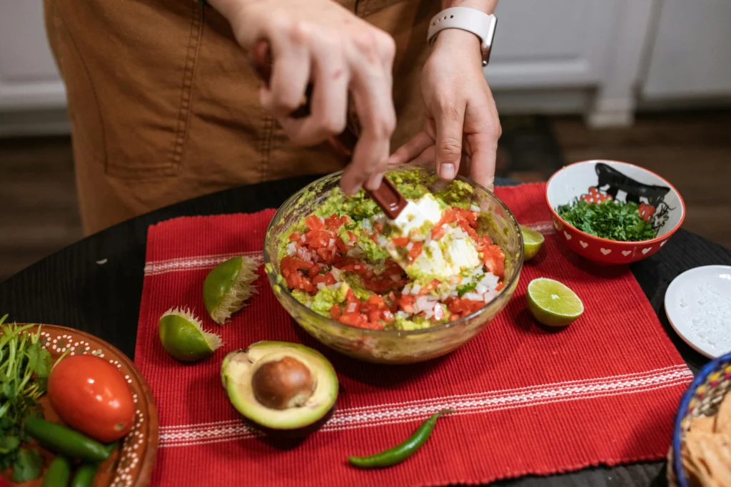 A Close-Up Shot of a Person Making a Guacamole Salsa