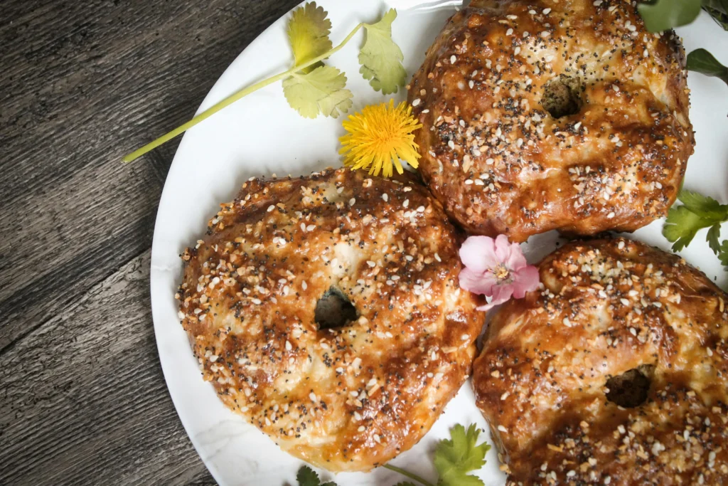 utopia bagels in Plate with Flowers and Coriander Garnish