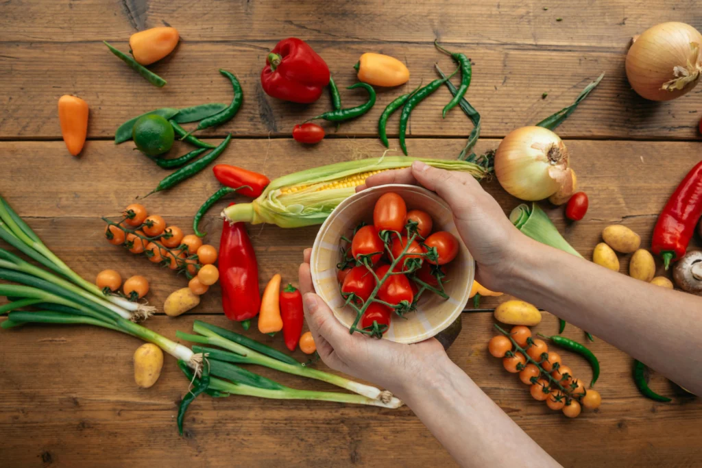 Person Holding a Bowl with Red Tomatoes