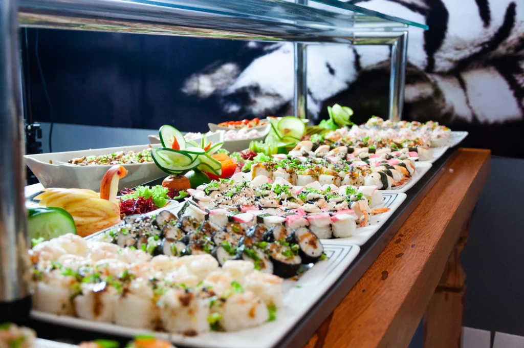 california roll sushi on White Plates on Brown Wooden Table