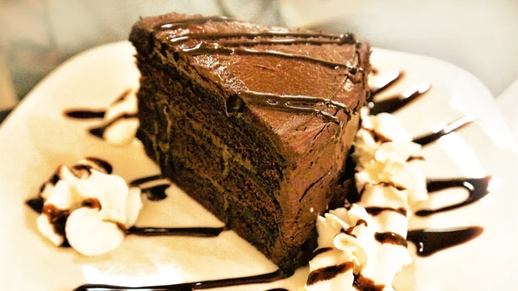 Chocolate cookie crust being pressed into pie dish for Mississippi Mud Pie