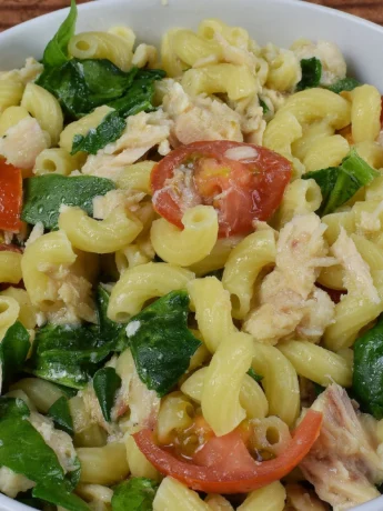 Cooked elbow macaroni noodles in a bowl, ready to be mixed with creamy dressing