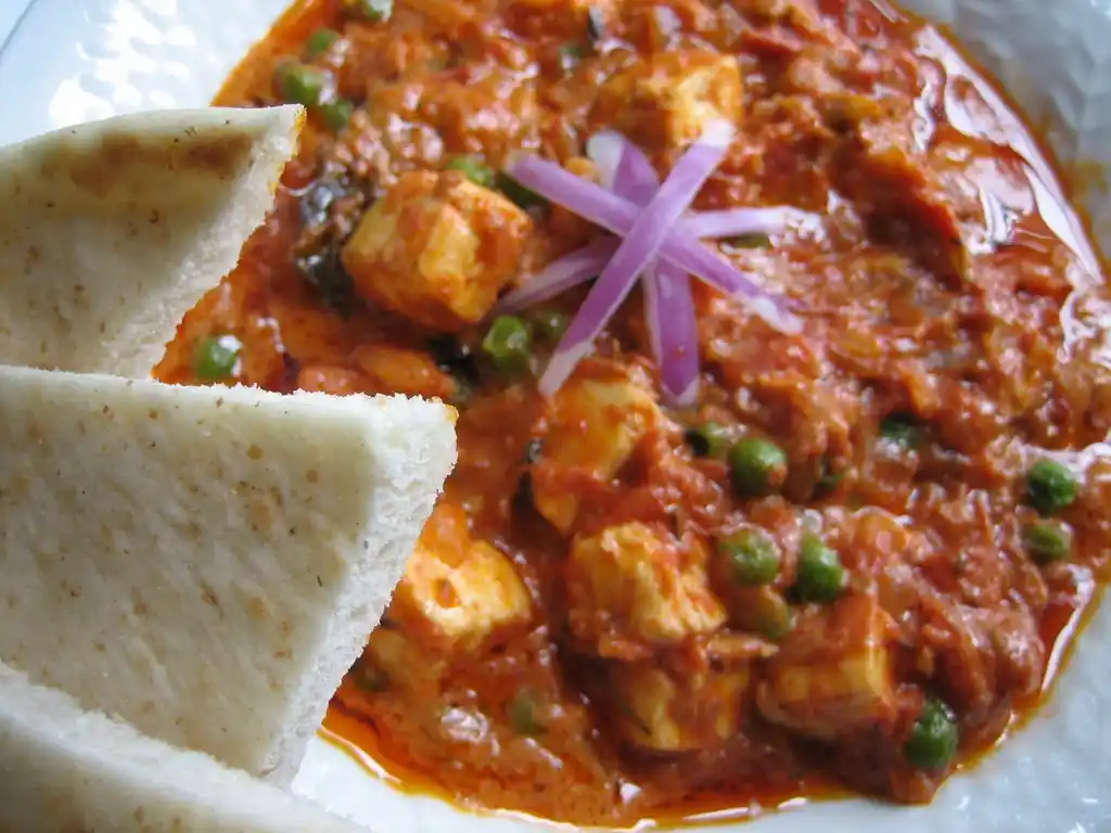 Matar Paneer garnished with fresh coriander leaves and ready to serve