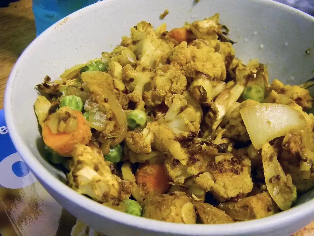 Freshly chopped cilantro garnishing the cooked Aloo Gobi, adding a burst of color and flavor