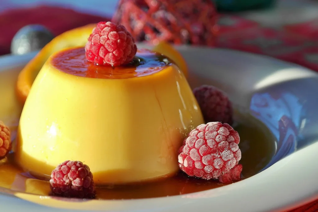 Homemade flan with a golden caramel topping, garnished with fresh berries