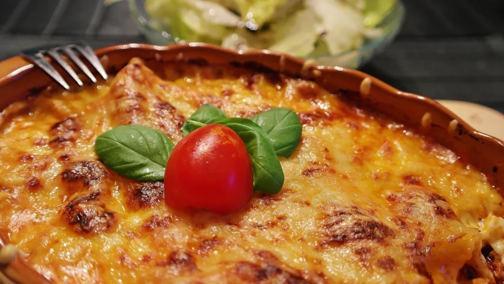 Golden brown Queso Fundido topped with diced tomatoes and jalapeños, served with tortilla chips