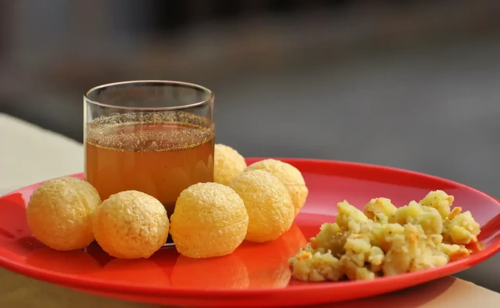 People enjoying Pani Puri at a gathering, showcasing the communal enjoyment of this street food