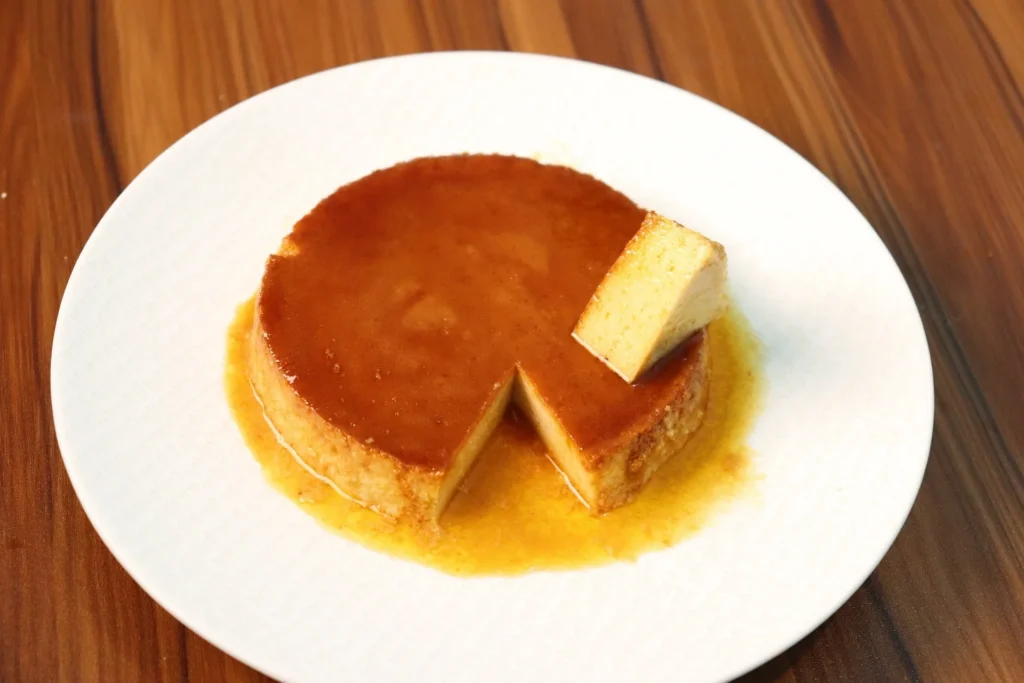 Classic flan recipe showcased on a rustic wooden table, ready to be served