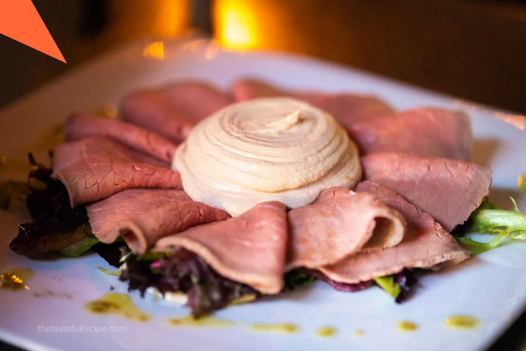 A serving platter of Vitello Tonnato, ready to be served