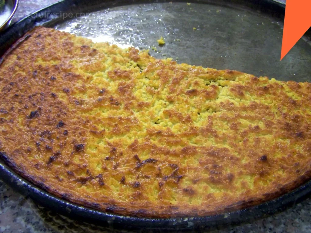 Golden-brown Farinata just out of the oven, cooling in a cast-iron skillet