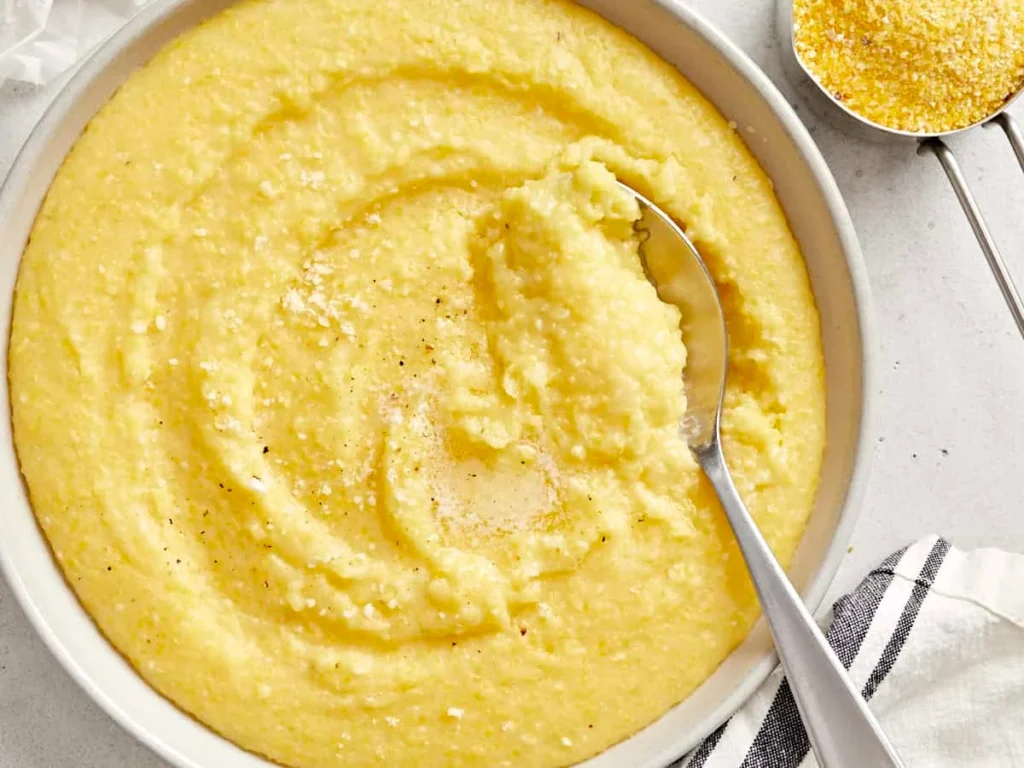 a bowl of Polenta food with a spoon