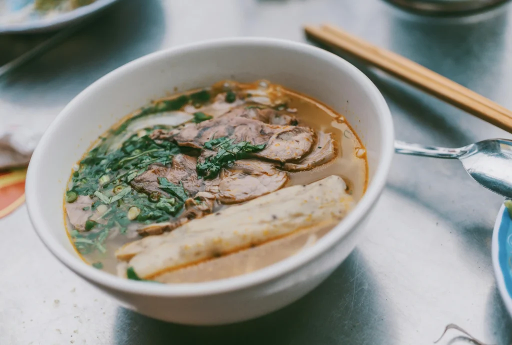 hot and sour soup With Meat on White Ceramic Bowl