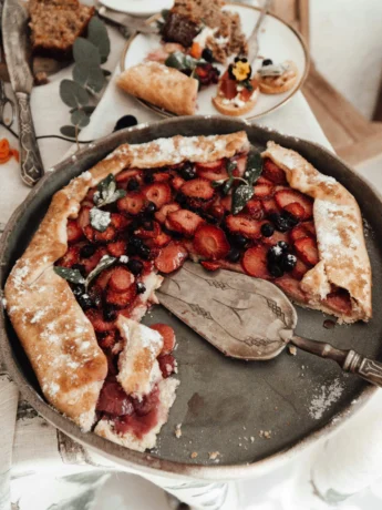 Tasty crostata in baking pan with spatula