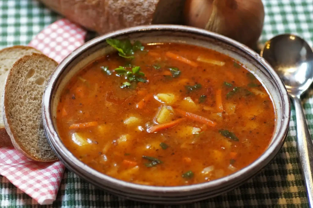 Hot and Sour Soup being ladled into a serving bowl, ready to eat