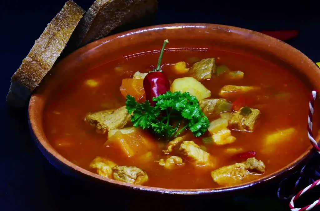 Hot and Sour Soup served with side dishes like spring rolls and steamed rice