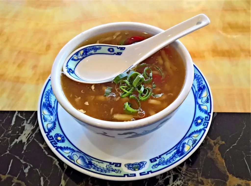 Vegetarian Hot and Sour Soup in a bowl, featuring tofu and fresh vegetables