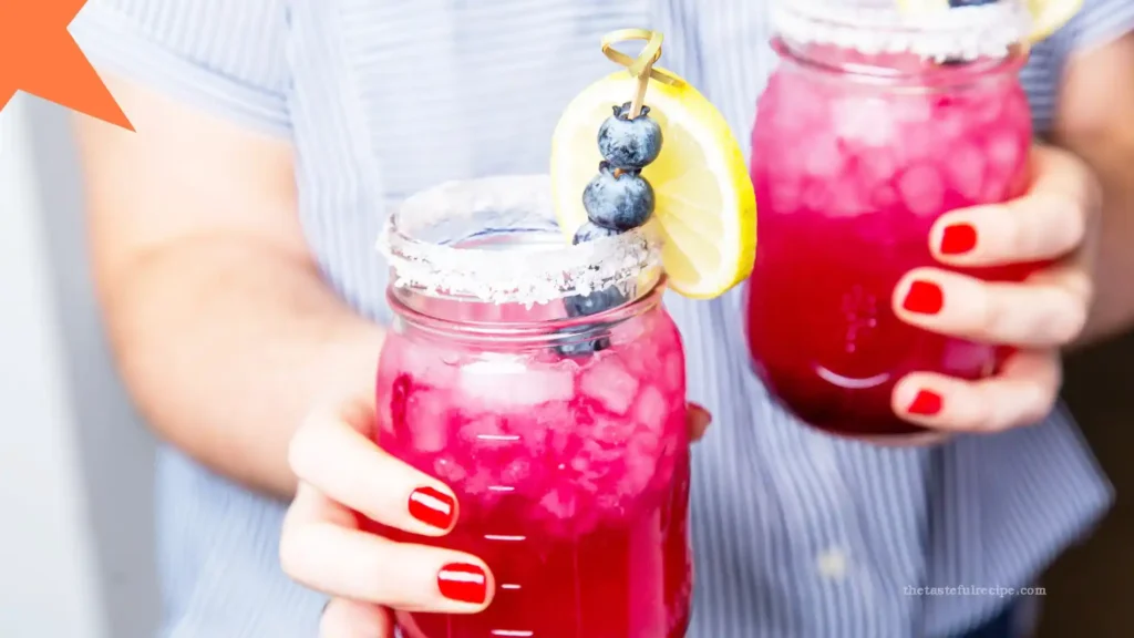 Family enjoying blueberry lemonade outdoors on a sunny day