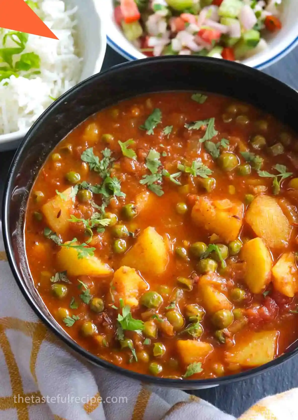 Sprinkling chopped coriander leaves over the cooked Aloo Matar