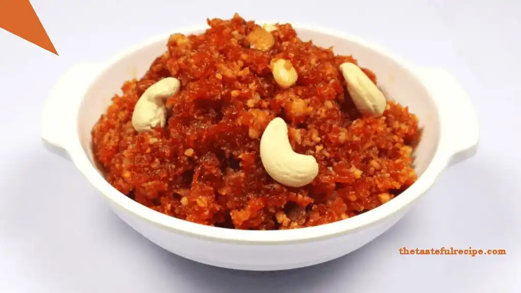 Gajar Halwa served in a traditional Indian bowl, garnished with silver leaf and nuts