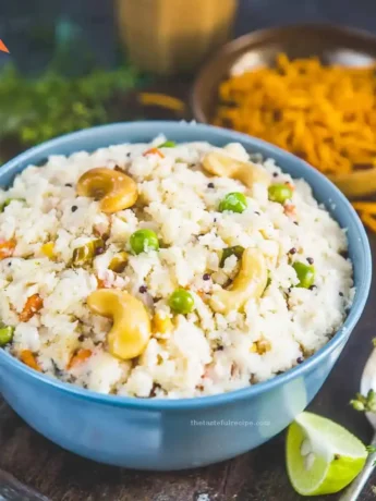 A serving of Upma on a plate with a lemon wedge for added flavor