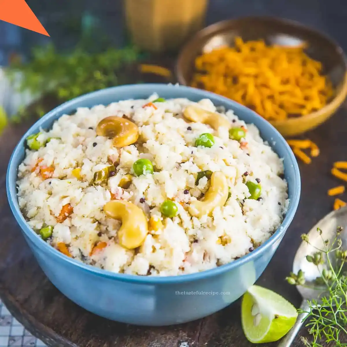 A serving of Upma on a plate with a lemon wedge for added flavor