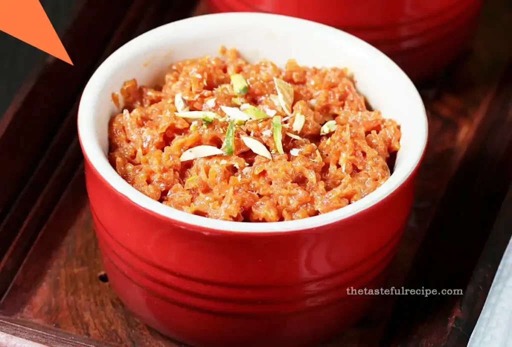 Gajar Halwa served in an ornate, decorative dish, topped with slivers of almonds and pistachios