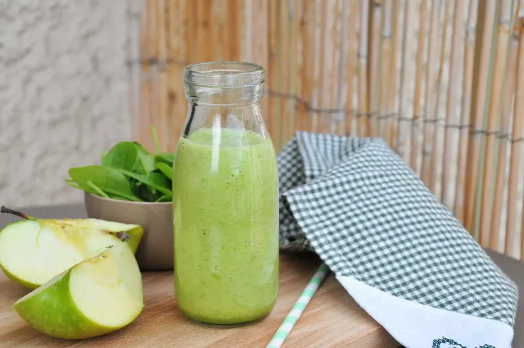 Green smoothie served as a healthy breakfast option with fruits and nuts