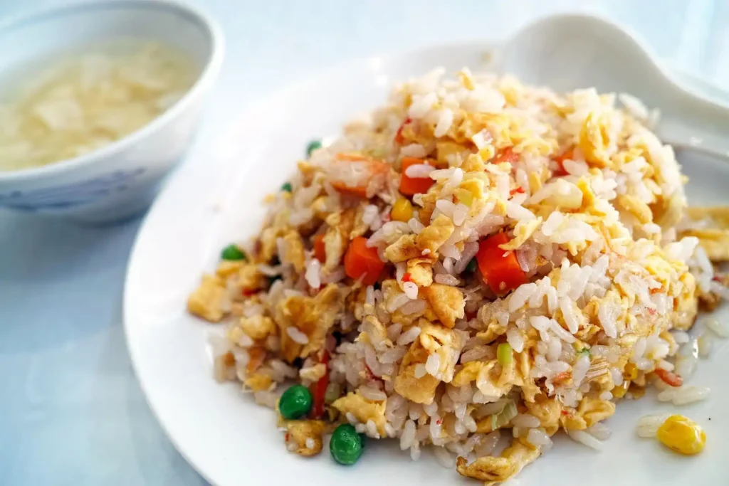 Shrimp Fried Rice drizzled with soy sauce, ready to be served