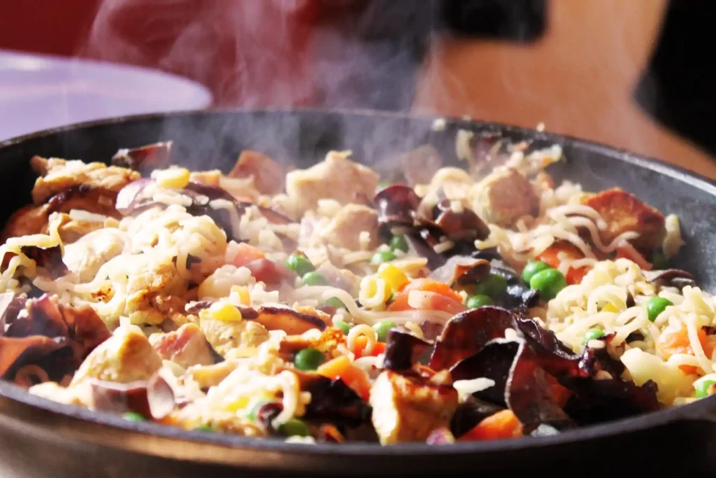 Vegetable oil heating in a large skillet for stir frying Chinese cabbage