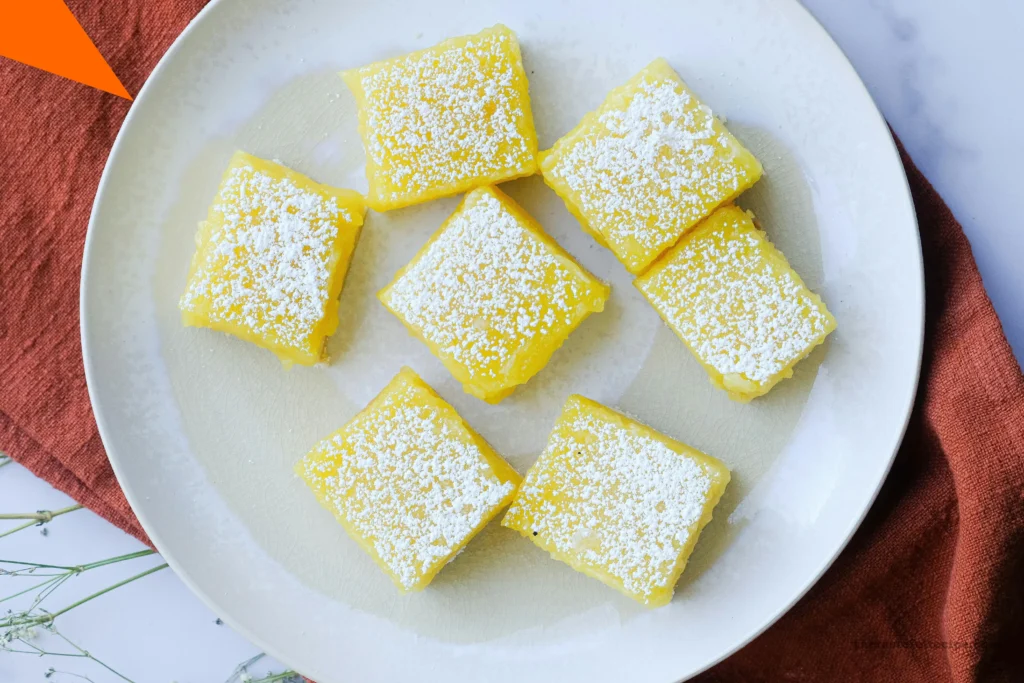 Whisking lemon filling ingredients together in a glass bowl for the lemon bars recipe