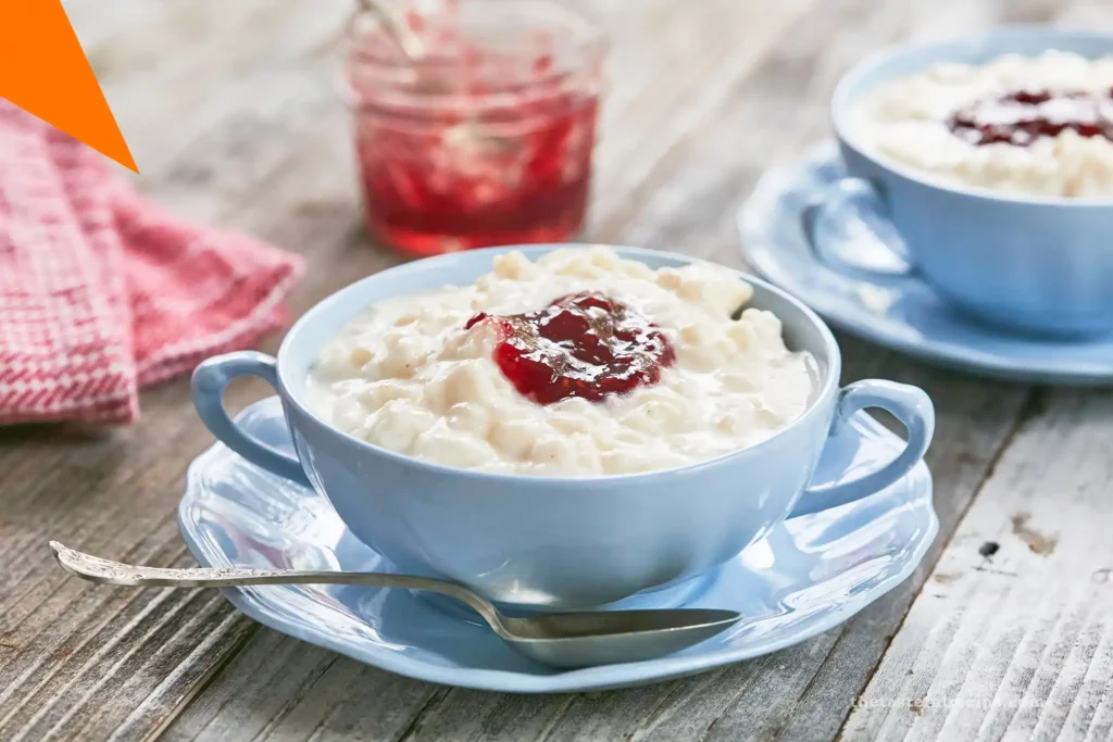 Close-up of homemade rice pudding mixed with raisins, served in a white bowl