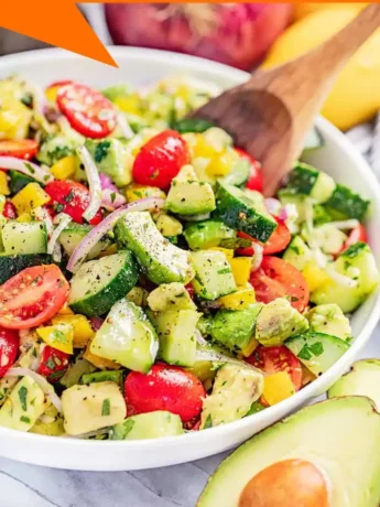 Refreshing avocado salad garnished with cilantro and lime