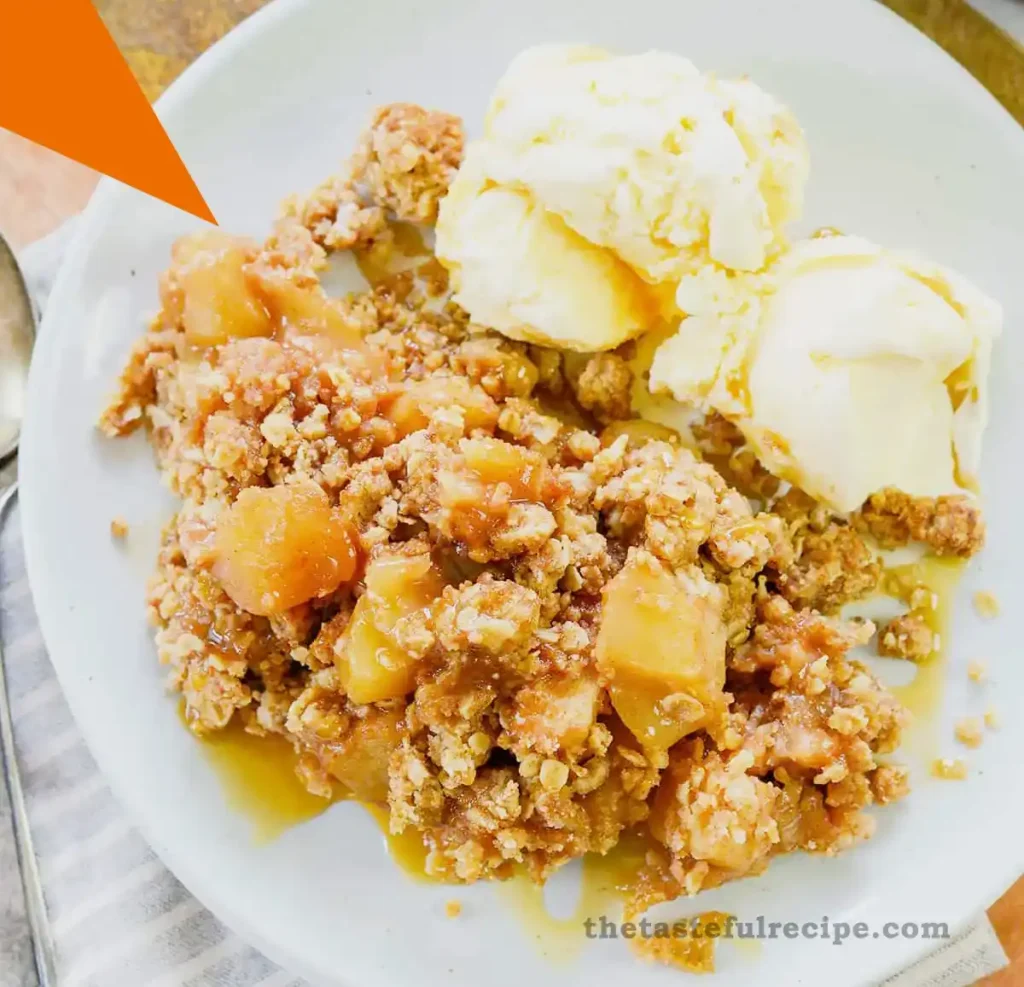 A spoonful of apple crumble showing the juicy apple filling and crispy topping