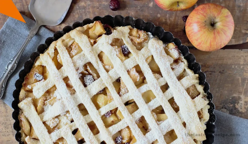 Homemade apple crumble served with whipped cream on a rustic table