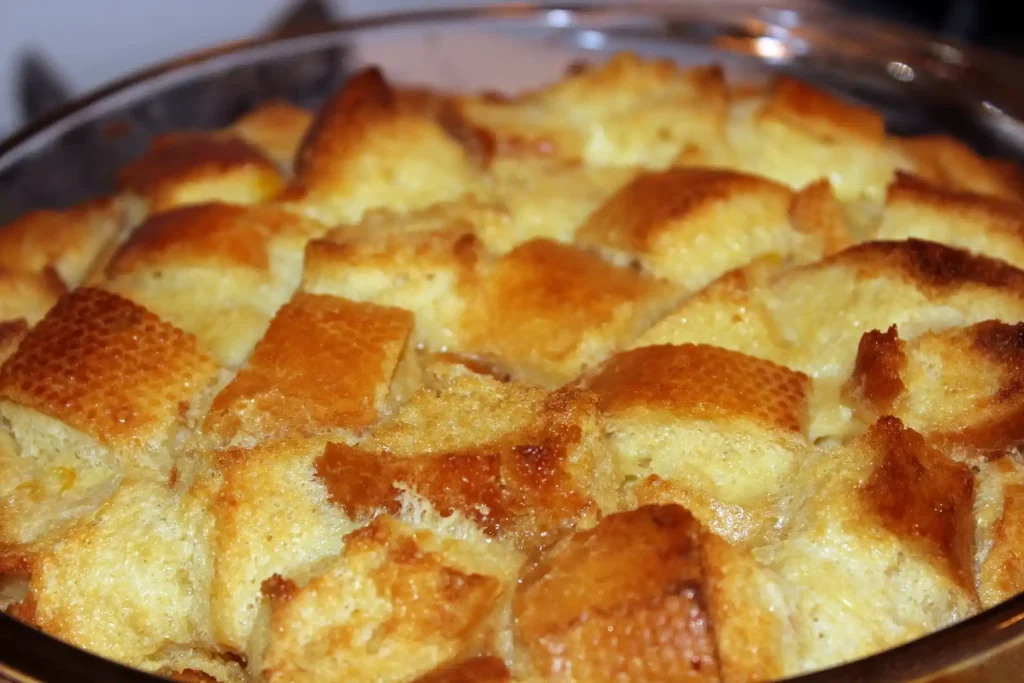 Close-up of freshly baked Bread Pudding topped with a drizzle of caramel sauce