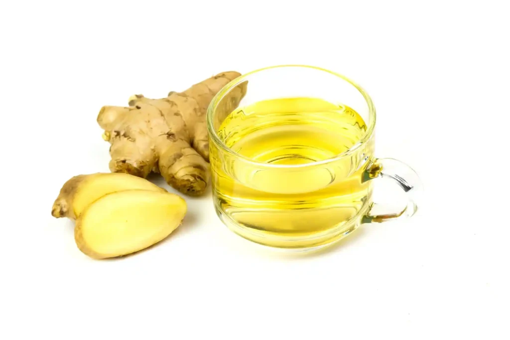 Fresh ginger slices being added to boiling water for Ginger Tea