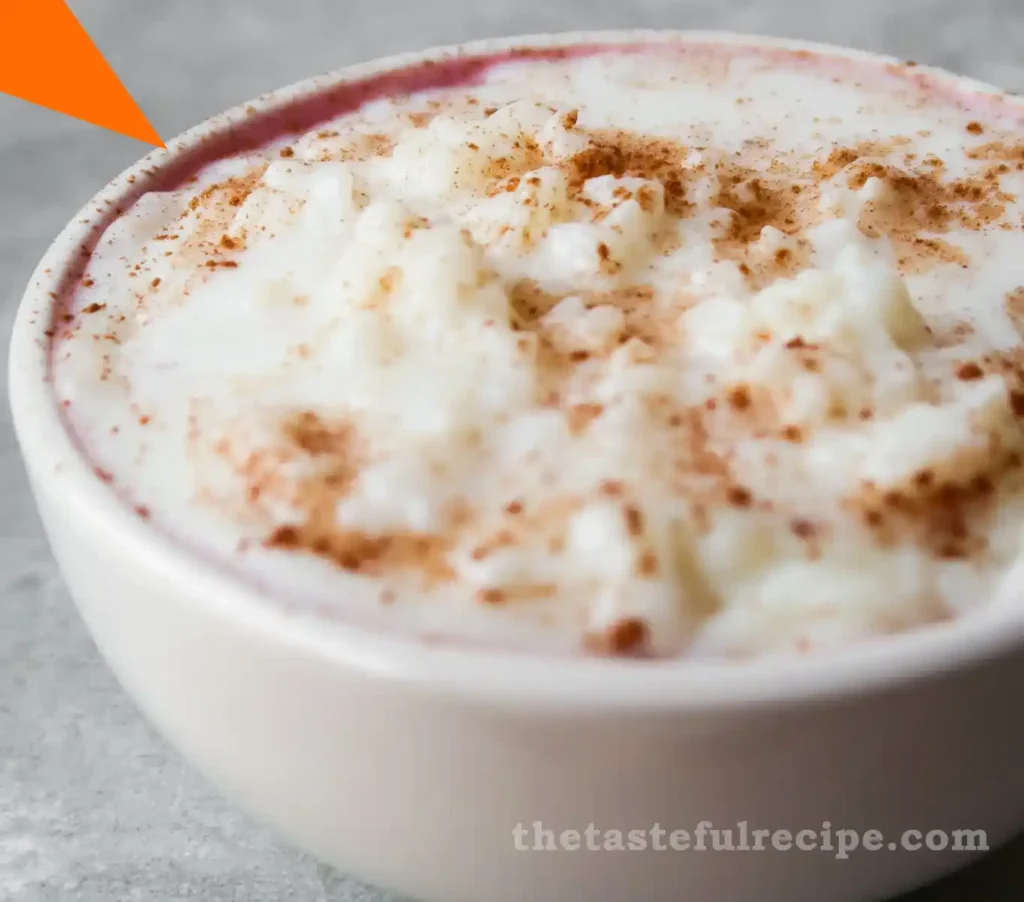 A bowl of creamy rice pudding topped with cinnamon, perfect for a comforting dessert