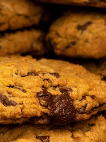 Vegan oatmeal raisin cookies baking in the oven, turning golden brown with a soft and chewy interior