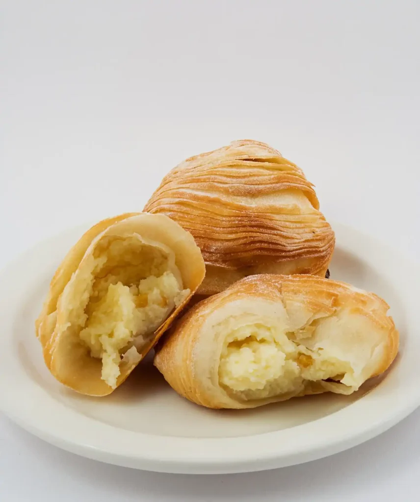 Freshly baked Sfogliatelle with golden, flaky layers.