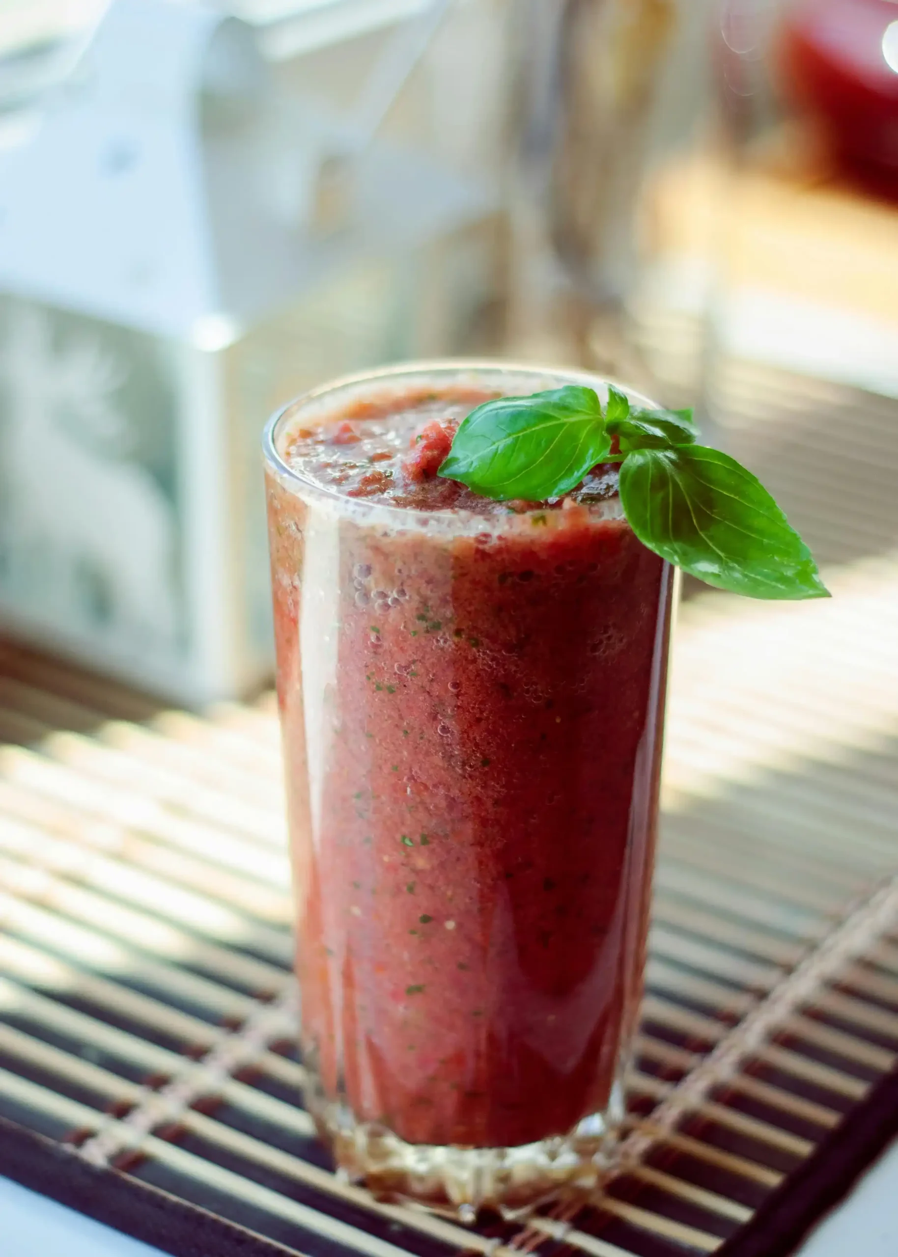 A Pomegranate Juice with Green Leaves on Top