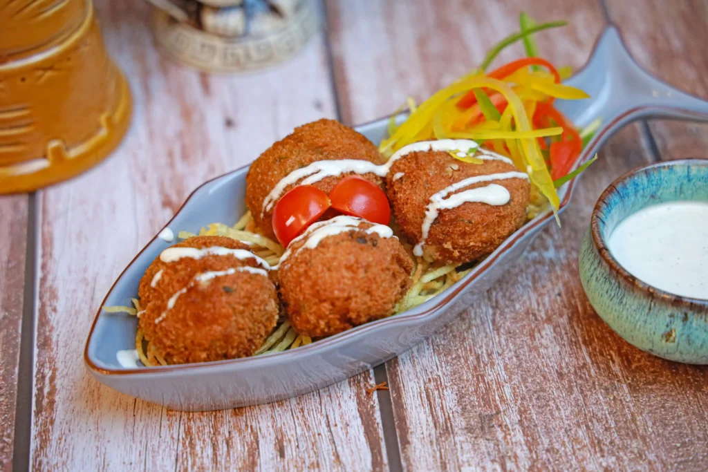 A plate of Crab Cakes Recipe with a fish and vegetables